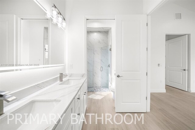 4308 3rd St SW, Lehigh Acres, FL 33976 - full bathroom featuring wood finished floors, a marble finish shower, and double vanity
