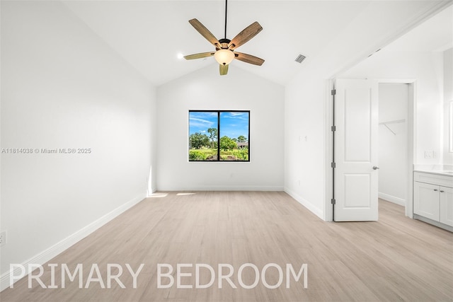 4308 3rd St SW, Lehigh Acres, FL 33976 - unfurnished bedroom featuring light wood-style flooring, vaulted ceiling, baseboards, and a ceiling fan