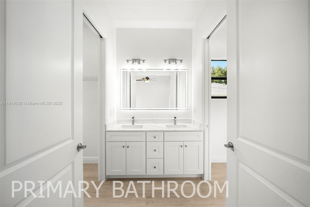 4308 3rd St SW, Lehigh Acres, FL 33976 - full bath with double vanity, wood finished floors, and baseboards
