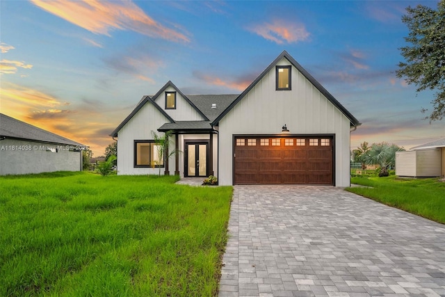 4308 3rd St SW, Lehigh Acres, FL 33976 - modern farmhouse featuring an attached garage, decorative driveway, and a yard