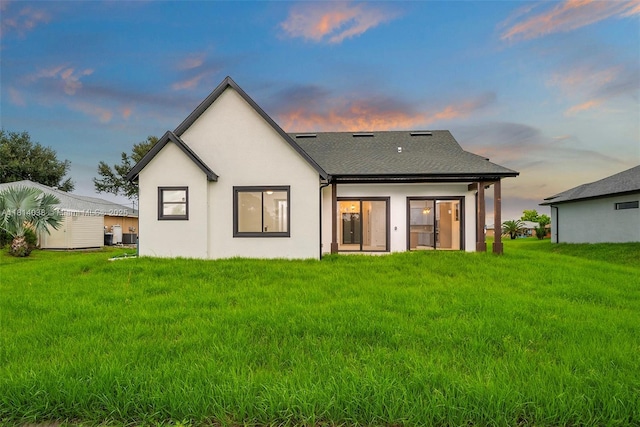4308 3rd St SW, Lehigh Acres, FL 33976 - back of house featuring a lawn, stucco siding, and a shingled roof
