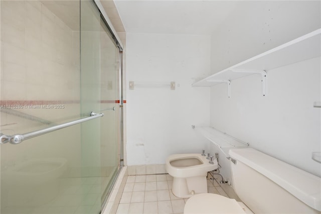 995 SW 84th Ave Unit 126, Miami, FL 33144 - bathroom featuring toilet, a stall shower, a bidet, and tile patterned flooring