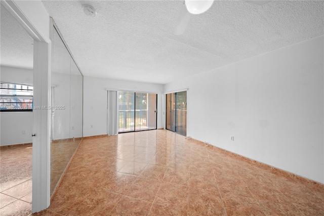 995 SW 84th Ave Unit 126, Miami, FL 33144 - spare room with plenty of natural light, a textured ceiling, tile patterned floors, and a smoke detector