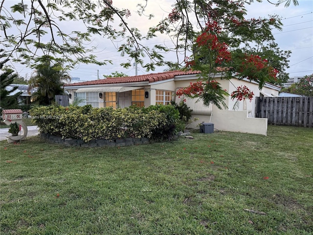 1435 NE 182nd St, North Miami Beach, FL 33162 - view of property exterior with stucco siding and a tiled roof