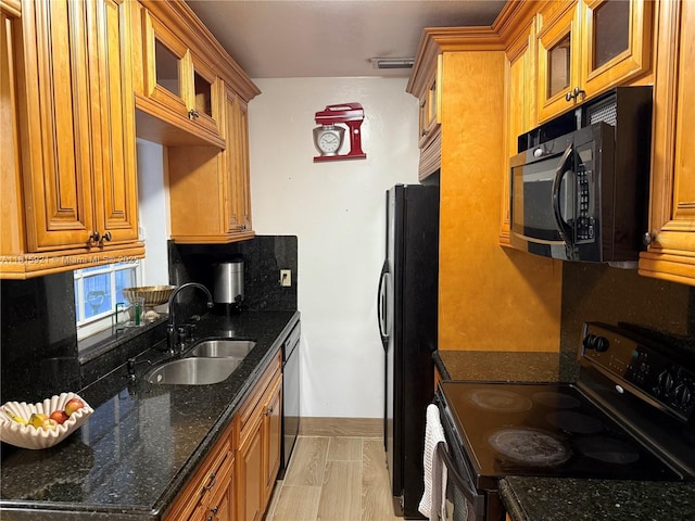 1435 NE 182nd St, North Miami Beach, FL 33162 - kitchen featuring black appliances, a sink, brown cabinetry, and dark stone countertops