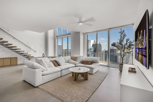 92 SW 3rd St Unit 5204, Miami, FL 33130 - living room featuring floor to ceiling windows, a ceiling fan, stairs, and concrete floors
