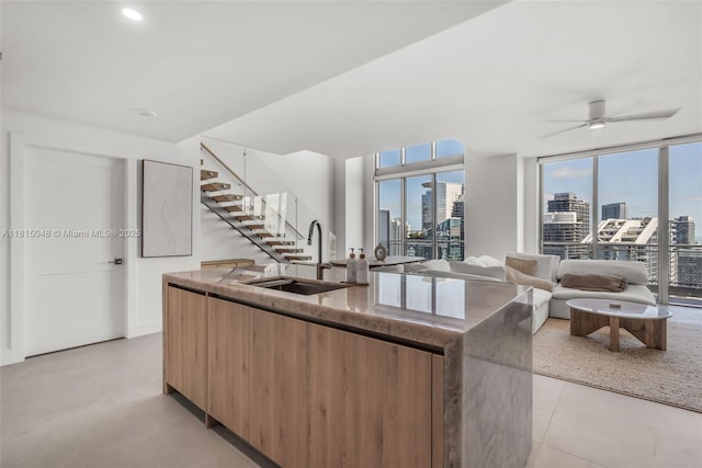 92 SW 3rd St Unit 5204, Miami, FL 33130 - kitchen with a sink, a view of skyline, modern cabinets, a kitchen island with sink, and healthy amount of natural light