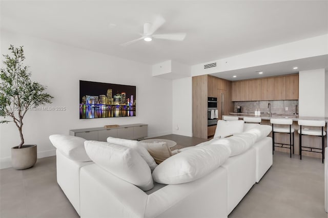 92 SW 3rd St Unit 5204, Miami, FL 33130 - living room with ceiling fan, finished concrete flooring, recessed lighting, and baseboards