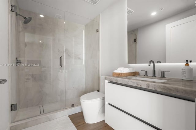 92 SW 3rd St Unit 5204, Miami, FL 33130 - bathroom featuring vanity, a marble finish shower, toilet, wood finished floors, and recessed lighting
