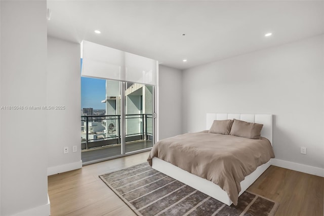 92 SW 3rd St Unit 5204, Miami, FL 33130 - bedroom with wood finished floors, access to exterior, baseboards, and recessed lighting