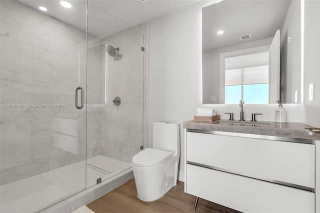 92 SW 3rd St Unit 5204, Miami, FL 33130 - full bath featuring wood finished floors, a marble finish shower, vanity, toilet, and recessed lighting