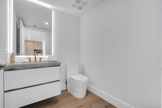 92 SW 3rd St Unit 5204, Miami, FL 33130 - bathroom with wood finished floors, vanity, toilet, baseboards, and recessed lighting