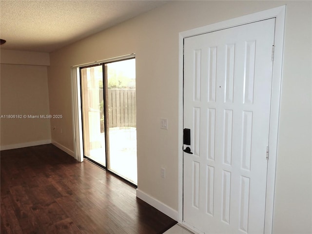 4226 42nd Way, West Palm Beach, FL 33407 - foyer entrance with baseboards, dark wood finished floors, and a textured ceiling