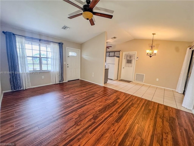 2016 Mariner Ct, La Belle, FL 33935 - unfurnished living room featuring ceiling fan, lofted ceiling, a chandelier, wood finished floors, and baseboards
