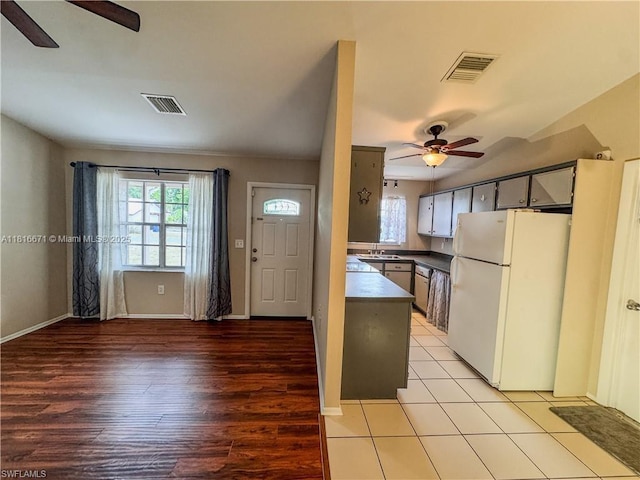 2016 Mariner Ct, La Belle, FL 33935 - kitchen with freestanding refrigerator, ceiling fan, dark countertops, and light wood finished floors