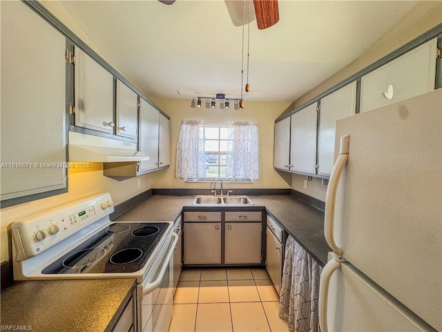 2016 Mariner Ct, La Belle, FL 33935 - kitchen featuring white appliances, under cabinet range hood, a sink, dark countertops, and light tile patterned floors