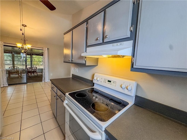 2016 Mariner Ct, La Belle, FL 33935 - kitchen with white range with electric stovetop, under cabinet range hood, dark countertops, light tile patterned floors, and hanging light fixtures