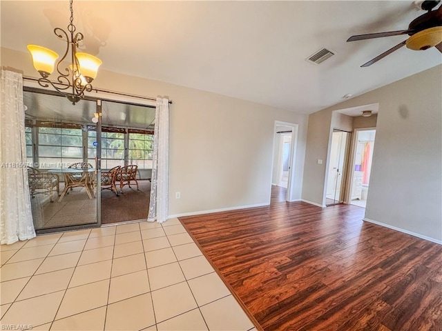 2016 Mariner Ct, La Belle, FL 33935 - spare room with a ceiling fan, wood finished floors, a chandelier, lofted ceiling, and baseboards