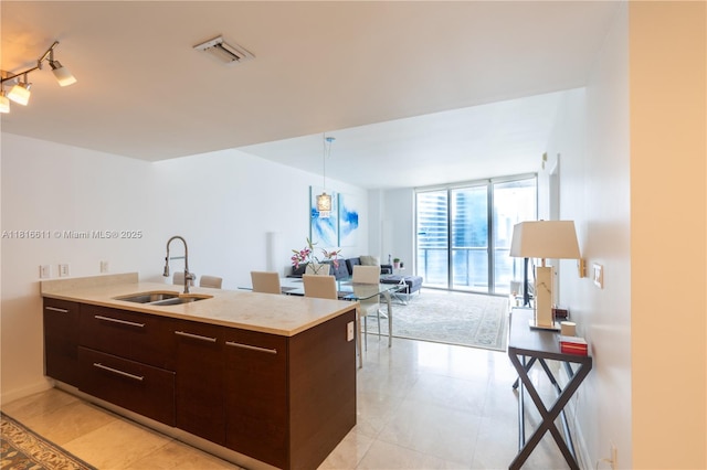 475 Brickell Ave Unit 3512, Miami, FL 33131 - kitchen featuring a sink, dark brown cabinets, light countertops, modern cabinets, and open floor plan