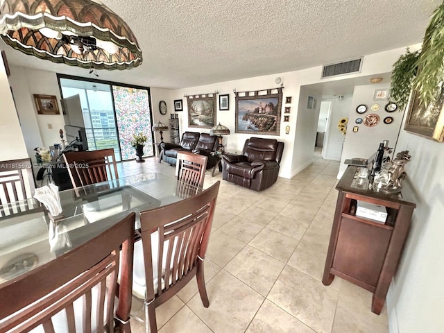 1100 Saint Charles Pl Unit 712, Pembroke Pines, FL 33026 - dining area featuring a textured ceiling and light tile patterned floors