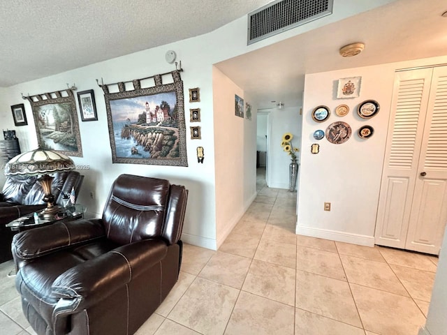1100 Saint Charles Pl Unit 712, Pembroke Pines, FL 33026 - living area with light tile patterned flooring, a textured ceiling, and baseboards