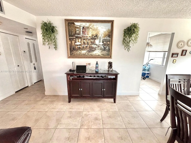1100 Saint Charles Pl Unit 712, Pembroke Pines, FL 33026 - hallway with a textured ceiling, light tile patterned floors, and baseboards