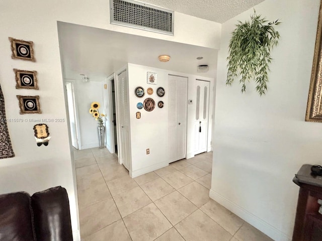 1100 Saint Charles Pl Unit 712, Pembroke Pines, FL 33026 - corridor with light tile patterned flooring, baseboards, and a textured ceiling