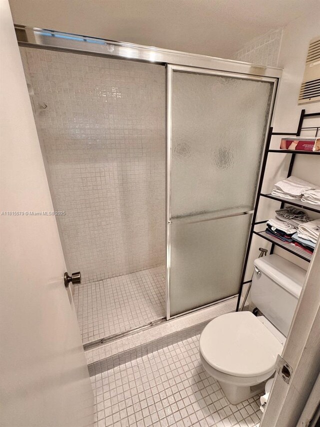 1100 Saint Charles Pl Unit 712, Pembroke Pines, FL 33026 - full bathroom featuring toilet, a shower stall, and tile patterned flooring