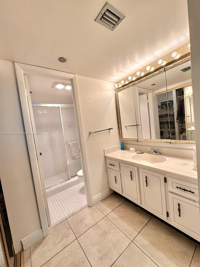1100 Saint Charles Pl Unit 712, Pembroke Pines, FL 33026 - bathroom featuring vanity, a shower stall, tile patterned flooring, toilet, and baseboards