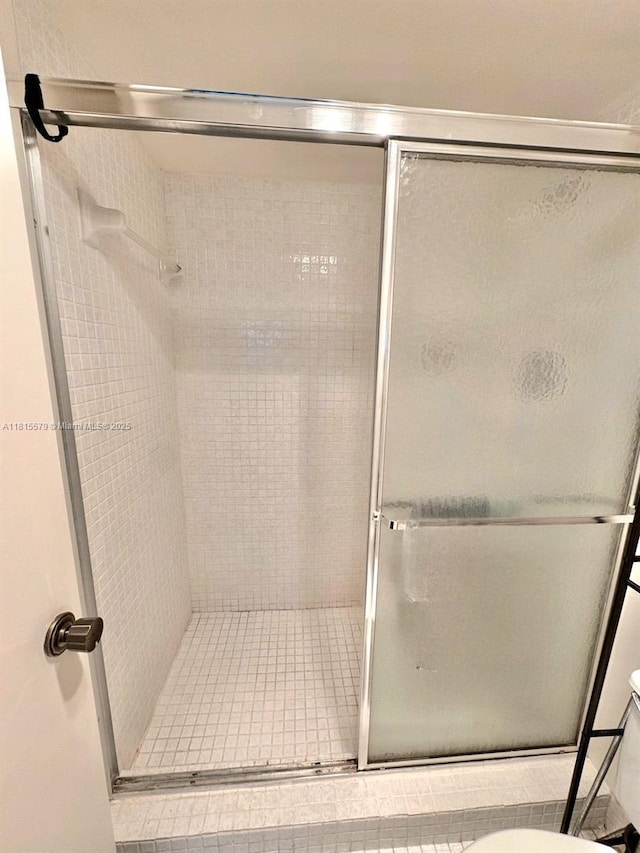 1100 Saint Charles Pl Unit 712, Pembroke Pines, FL 33026 - bathroom featuring a shower stall, toilet, and tile patterned floors