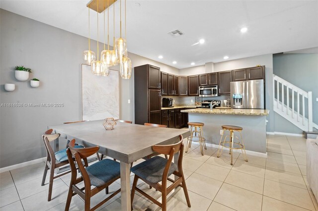 4164 Cascada Cir, Cooper City, FL 33024 - dining area with light tile patterned floors, a chandelier, stairs, baseboards, and recessed lighting