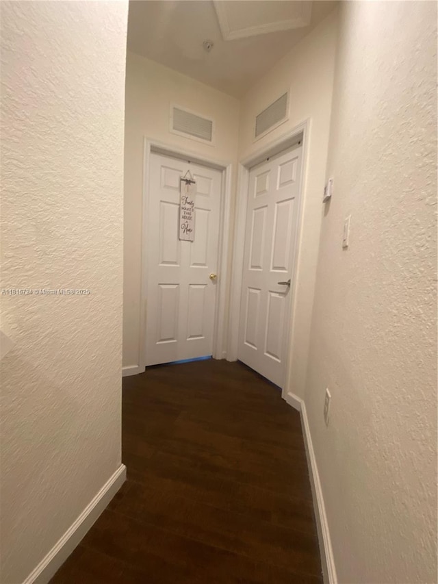 11603 NW 89th St Unit 214, Doral, FL 33178 - hallway with a textured wall, baseboards, and dark wood-style flooring