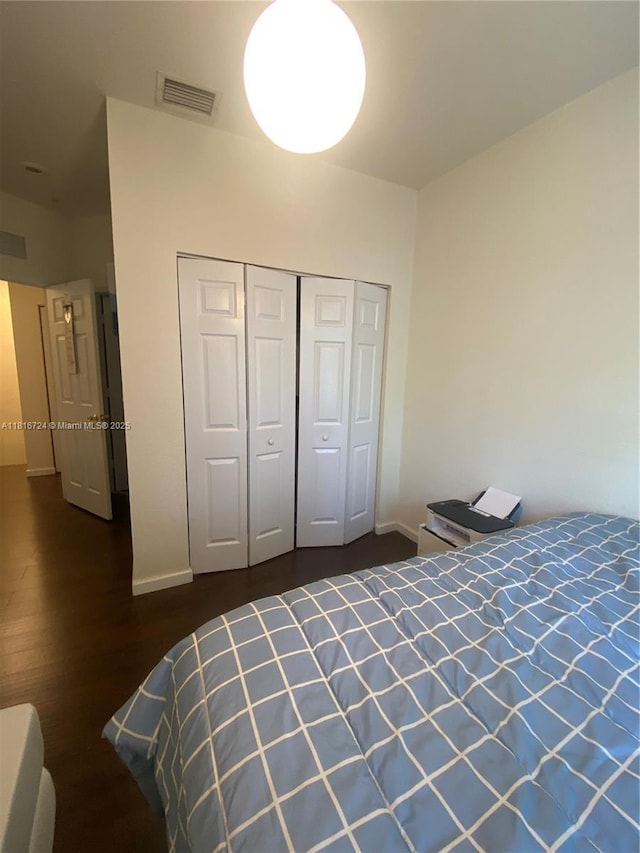 11603 NW 89th St Unit 214, Doral, FL 33178 - unfurnished bedroom with baseboards, dark wood-style floors, and a closet