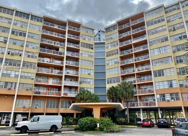2025 NE 164th St Unit 414, North Miami Beach, FL 33162 - view of apartment building / complex featuring uncovered parking