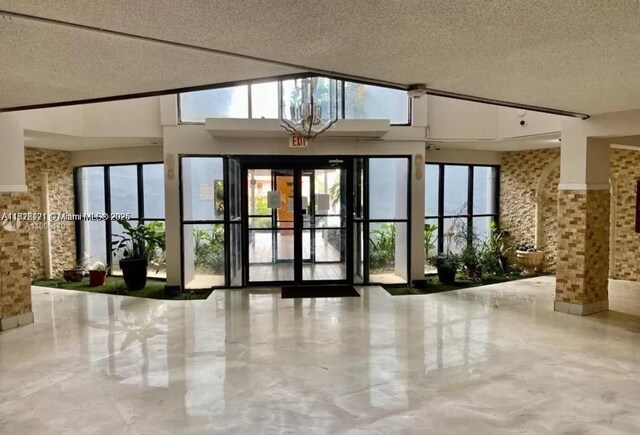 2025 NE 164th St Unit 414, North Miami Beach, FL 33162 - building lobby with a textured ceiling