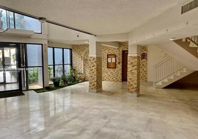 2025 NE 164th St Unit 414, North Miami Beach, FL 33162 - common area with stairs and a textured ceiling
