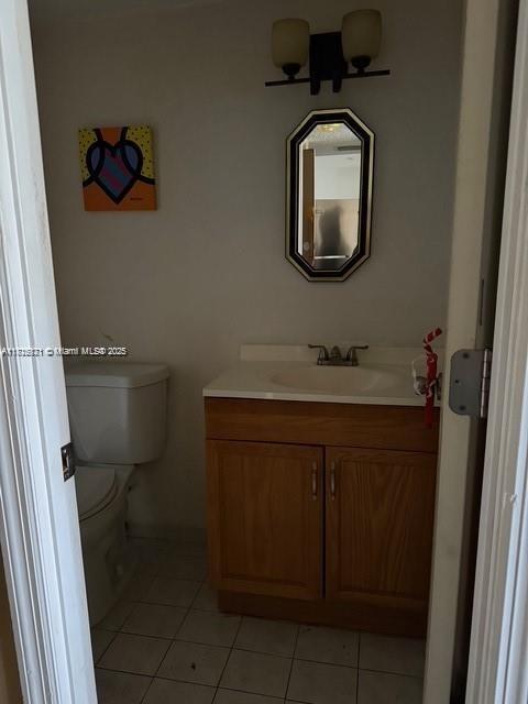 2025 NE 164th St Unit 414, North Miami Beach, FL 33162 - half bath featuring vanity, tile patterned floors, and toilet