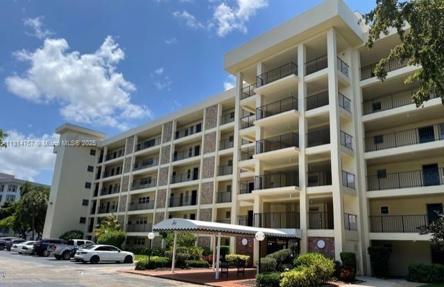2751 N Palm Aire Dr Unit 504, Pompano Beach, FL 33069 - view of apartment building / complex