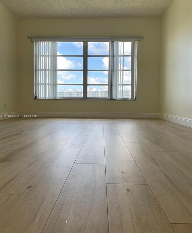 2751 N Palm Aire Dr Unit 504, Pompano Beach, FL 33069 - unfurnished room featuring wood finished floors and baseboards