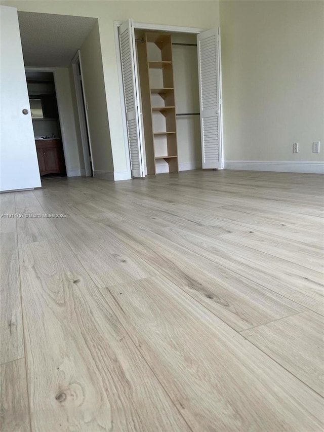 2751 N Palm Aire Dr Unit 504, Pompano Beach, FL 33069 - unfurnished living room featuring wood finished floors and baseboards