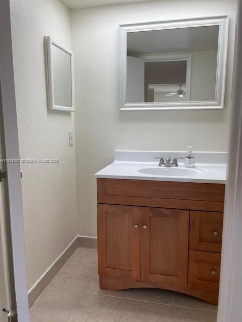 2751 N Palm Aire Dr Unit 504, Pompano Beach, FL 33069 - bathroom featuring vanity, tile patterned flooring, and baseboards