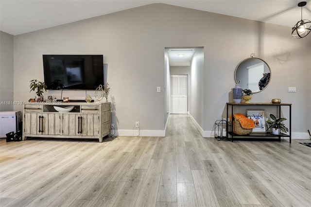 4760 SW 57th Ave, Davie, FL 33314 - living room featuring light wood-type flooring, lofted ceiling, and baseboards