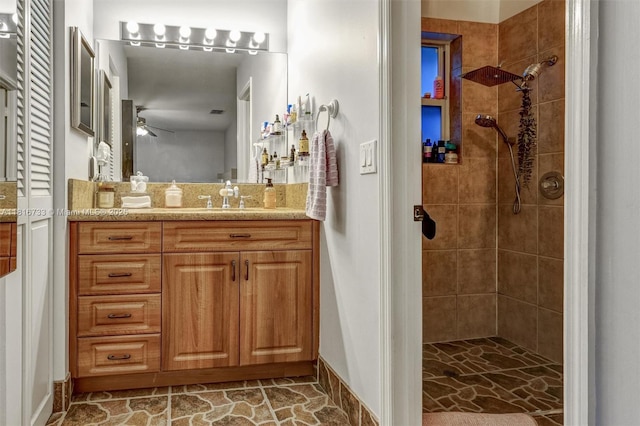 4760 SW 57th Ave, Davie, FL 33314 - bathroom with vanity, a ceiling fan, a tile shower, and baseboards