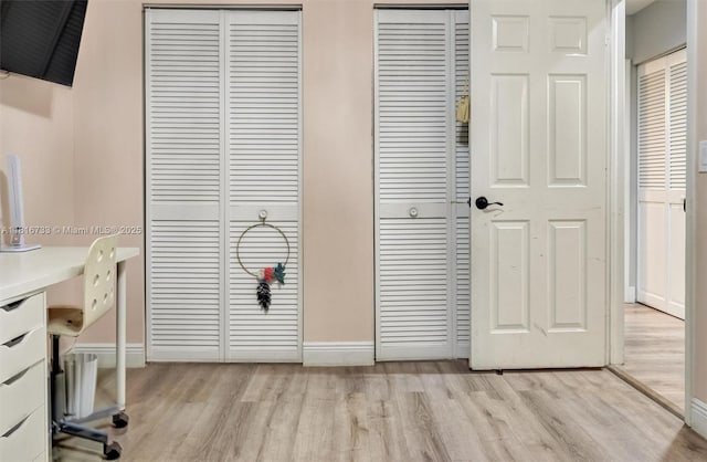 4760 SW 57th Ave, Davie, FL 33314 - unfurnished bedroom with two closets, light wood-style flooring, baseboards, and a desk