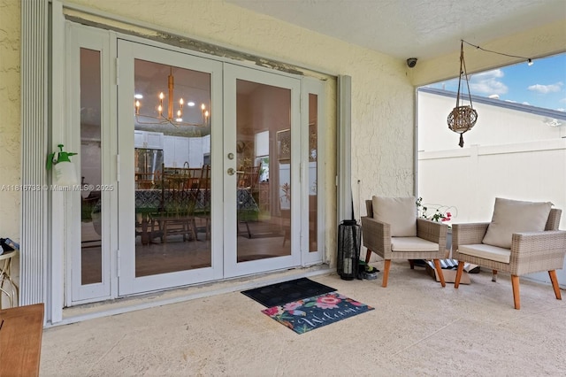 4760 SW 57th Ave, Davie, FL 33314 - view of exterior entry with french doors, a security system, and stucco siding