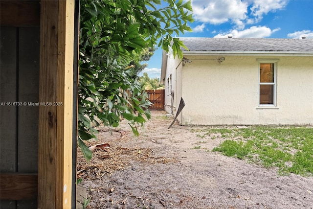 4760 SW 57th Ave, Davie, FL 33314 - view of side of home featuring stucco siding and a shingled roof