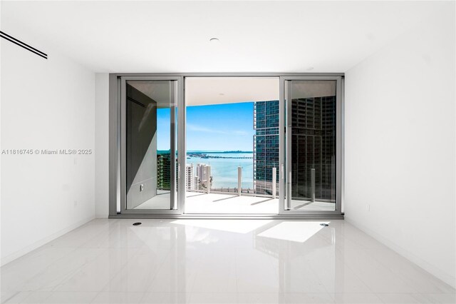 300 Biscayne Blvd Way Unit 3506, Miami, FL 33131 - empty room with a wall of windows, a water view, and baseboards