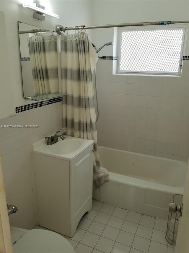 761 Euclid Ave Unit 12B, Miami Beach, FL 33139 - full bathroom featuring tile patterned flooring, vanity, shower / bath combo with shower curtain, toilet, and tile walls