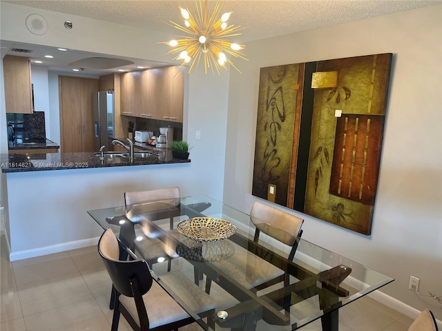 1717 N Bayshore Dr Unit A-1038, Miami, FL 33132 - dining area featuring light tile patterned floors, a textured ceiling, a chandelier, baseboards, and arched walkways