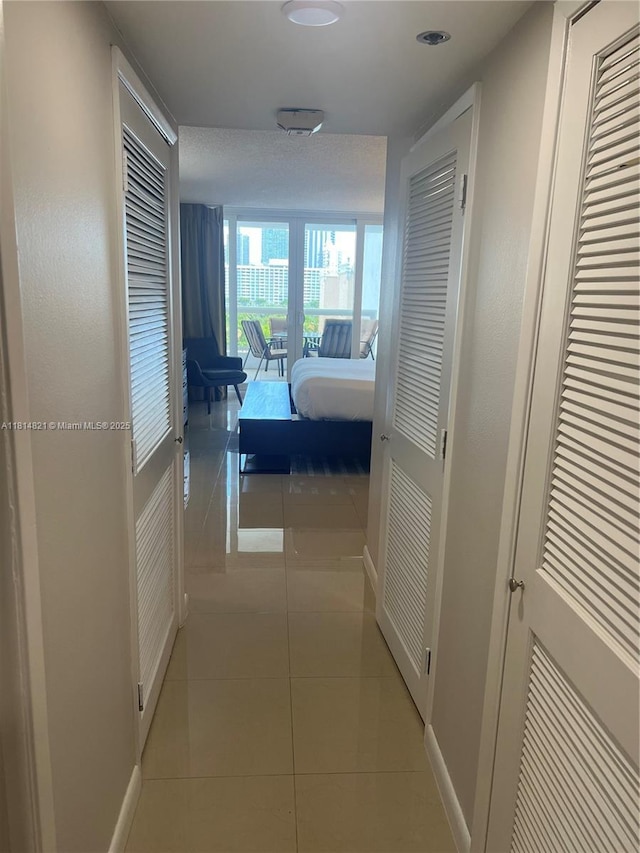 1717 N Bayshore Dr Unit A-1038, Miami, FL 33132 - hall with baseboards and light tile patterned floors